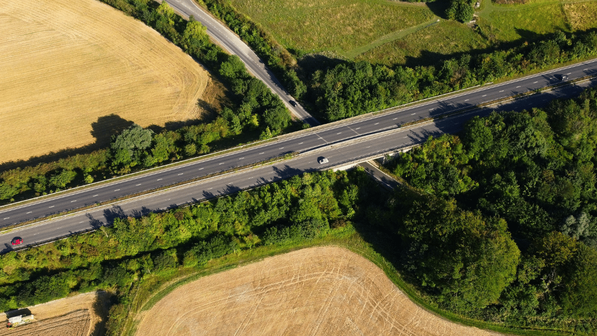 Aerial view of a highway with an inaccessible road running below it